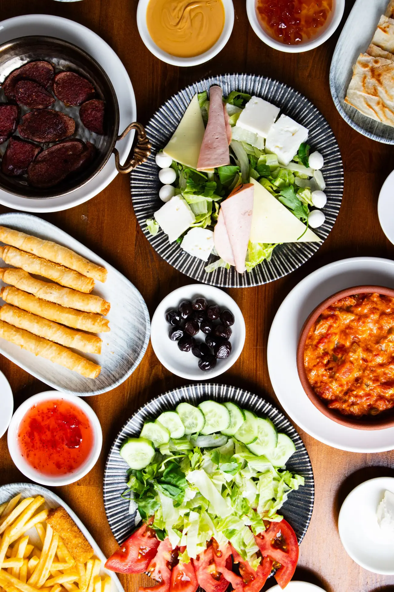 An overhead spread of shared dishes, illustrative photography