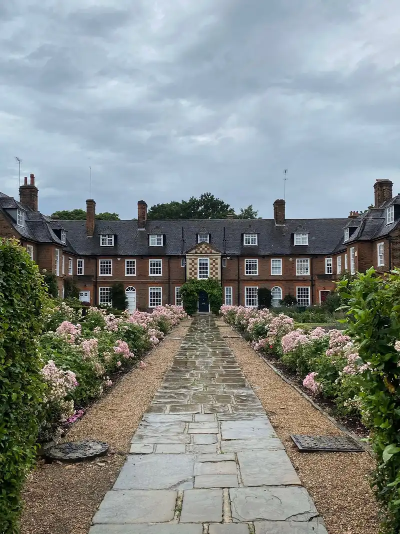 Stone path lined with pink flowers at a home in Hampstead Garden Suburb