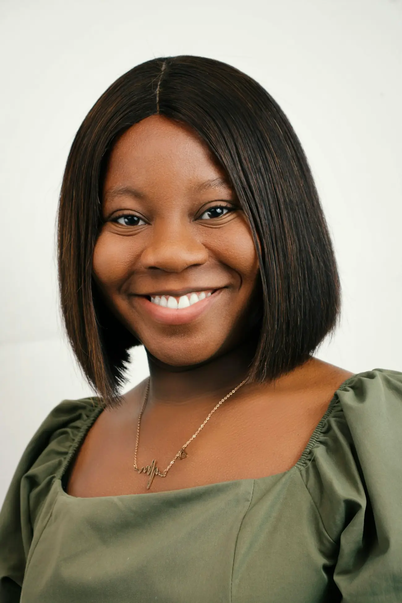 Smiling portrait with a sleek dark bob